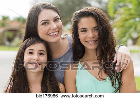 Mother and daughters smiling outdoors View Large Photo Image Stock Photograph - Mother and daughters smiling outdoors. Fotosearch