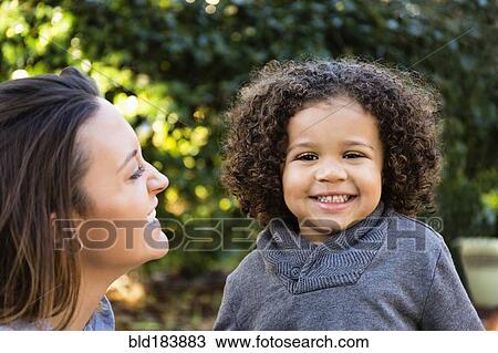 Mother and son smiling outdoors View Large Photo Image Stock Image - Mother and son smiling outdoors. Fotosearch