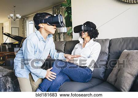 Mother and son using virtual reality goggles View Large Photo Image Stock Image - Mother and son using virtual reality goggles. Fotosearch
