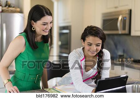 Mother helping daughter with homework View Large Photo Image Stock Image - Mother helping daughter with homework. Fotosearch