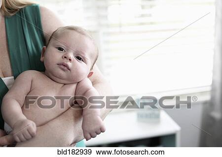 Stock Photo - Mother holding baby son. Fotosearch