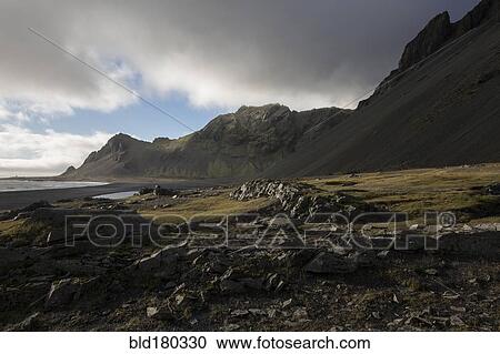 Stock Image - Mountains over rural field. Fotosearch