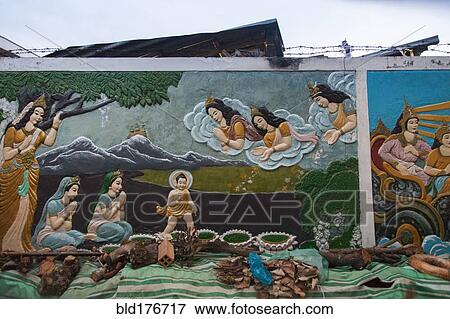 Stock Photo - Mural of Buddhist figures painted on wall. Fotosearch