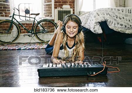 Native American girl playing keyboard in bedroom View Large Photo Image Stock Photograph - Native American girl playing keyboard in bedroom. Fotosearch
