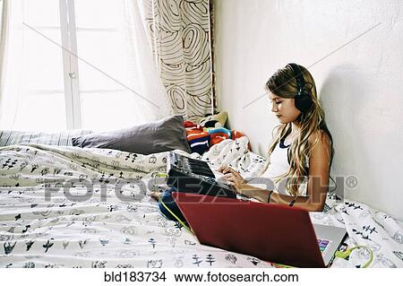 Native American girl recording music on bed View Large Photo Image Picture - Native American girl recording music on bed. Fotosearch