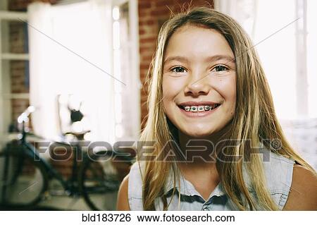 Stock Photograph - Native American girl smiling with braces. Fotosearch