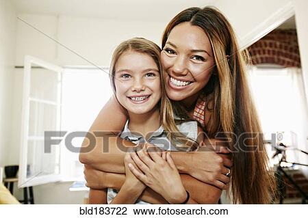 Stock Image - Native American mother and daughter hugging. Fotosearch