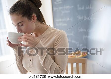Stock Photo - Native American woman drinking coffee in cafe. Fotosearch