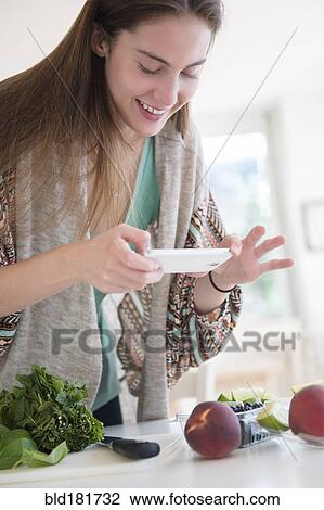 Native American woman photographing food View Large Photo Image Stock Image - Native American woman photographing food. Fotosearch