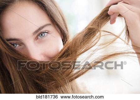 Stock Photograph - Native American woman playing with hair. Fotosearch