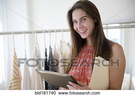 Stock Image - Native American woman working in store. Fotosearch