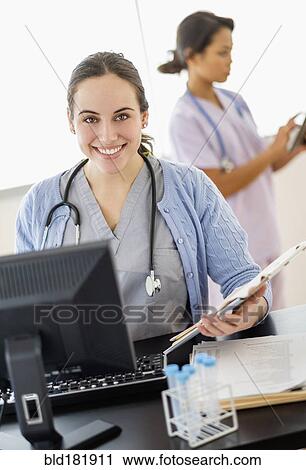 Stock Image - Nurse holding medical chart in hospital. Fotosearch