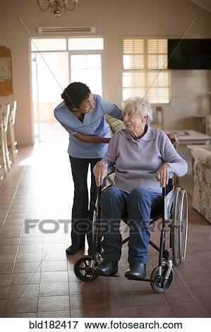Nurse talking to patient in wheelchair View Large Photo Image Stock Photo - Nurse talking to patient in wheelchair. Fotosearch