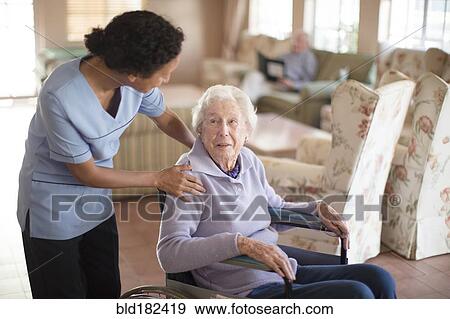 Nurse talking to patient in wheelchair View Large Photo Image Stock Photo - Nurse talking to patient in wheelchair. Fotosearch