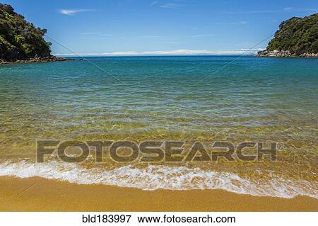 Stock Photo - Ocean waves on remote beach. Fotosearch