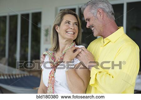 Stock Image - Older Caucasian couple hugging outdoors. Fotosearch