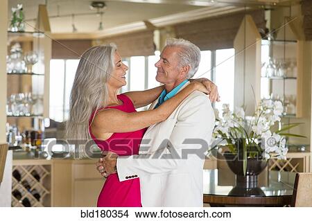 Picture - Older Caucasian couple hugging. Fotosearch