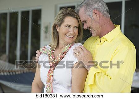 Stock Image - Older Caucasian couple hugging. Fotosearch