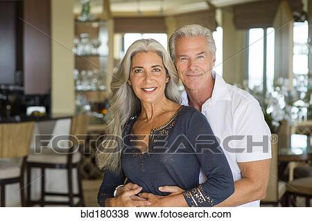 Stock Photo - Older Caucasian couple hugging. Fotosearch