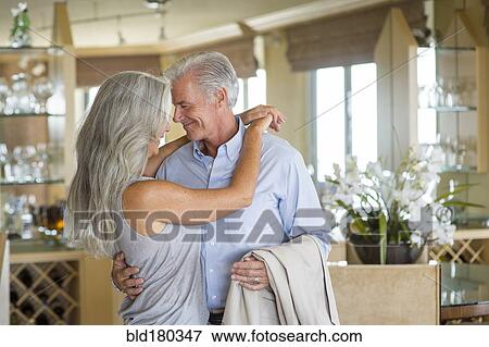 Stock Photo - Older Caucasian couple hugging. Fotosearch