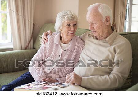 Older Caucasian couple looking at photo album View Large Photo Image Stock Image - Older Caucasian couple looking at photo album. Fotosearch