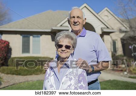 Stock Photo - Older Caucasian couple smiling in yard. Fotosearch