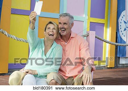 Stock Image - Older Caucasian couple taking selfie. Fotosearch