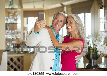 Stock Photography - Older Caucasian couple taking selfie. Fotosearch