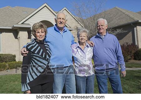 Older Caucasian friends smiling in yard View Large Photo Image Stock Photo - Older Caucasian friends smiling in yard. Fotosearch