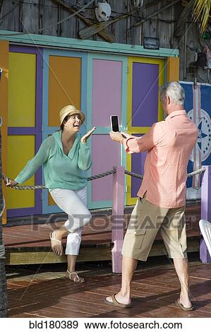 Stock Photo - Older Caucasian man photographing wife. Fotosearch