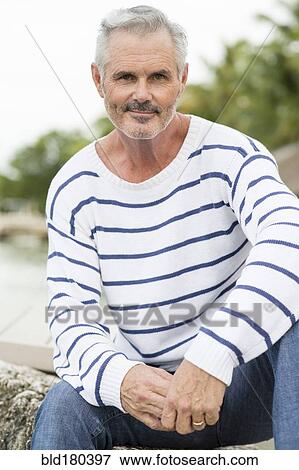 Older Caucasian man sitting outdoors View Large Photo Image Stock Photo - Older Caucasian man sitting outdoors. Fotosearch