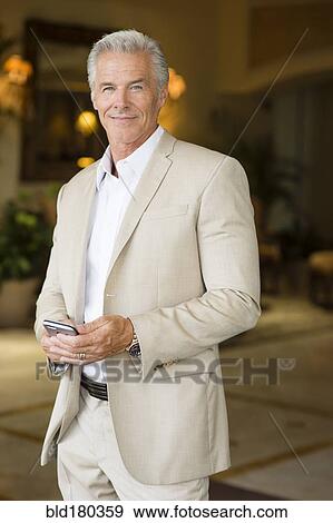 Older Caucasian man using cell phone outdoors View Large Photo Image Stock Photo - Older Caucasian man using cell phone outdoors. Fotosearch