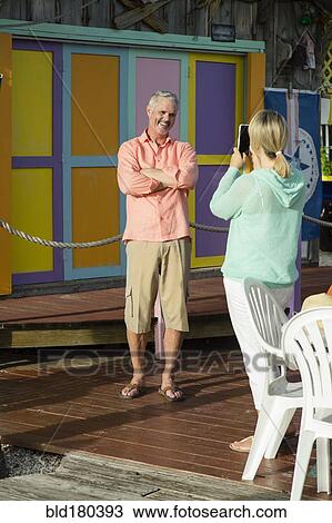 Older Caucasian woman photographing husband View Large Photo Image Stock Image - Older Caucasian woman photographing husband. Fotosearch