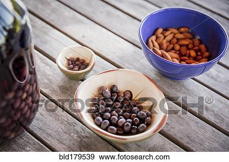 Olives with nuts on table View Large Photo Image Stock Photo - Olives with nuts on table. Fotosearch