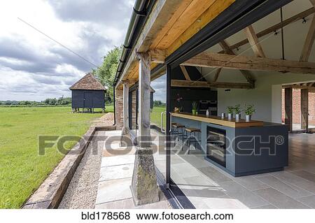 Stock Photo - Open-air kitchen and backyard in modern home. Fotosearch