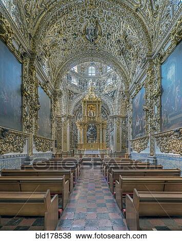 Stock Photo - Ornate altar and pews in church. Fotosearch