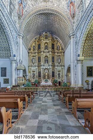 Stock Photograph - Ornate altar and pews in church. Fotosearch