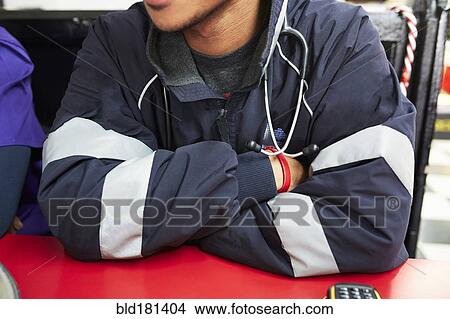 Picture - Paramedic sitting in restaurant. Fotosearch