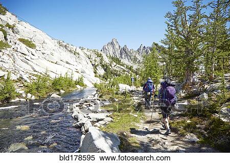 Stock Photography - People hiking near remote river. Fotosearch