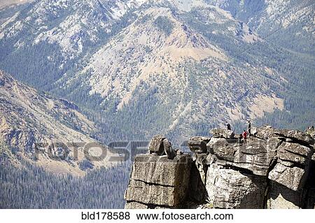 Stock Photo - People hiking on rocky hilltop. Fotosearch