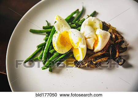 Stock Image - Plate of eggs, mushrooms and vegetables. Fotosearch