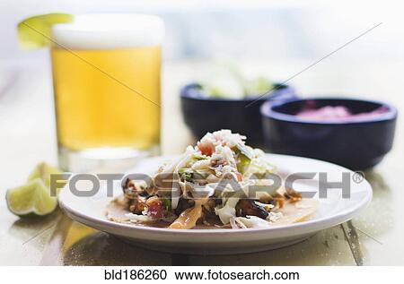 Stock Image - Plate of tacos with beer. Fotosearch