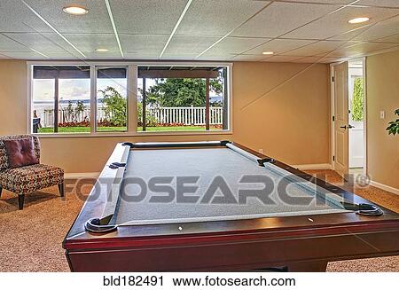 Stock Image - Pool table in game room. Fotosearch