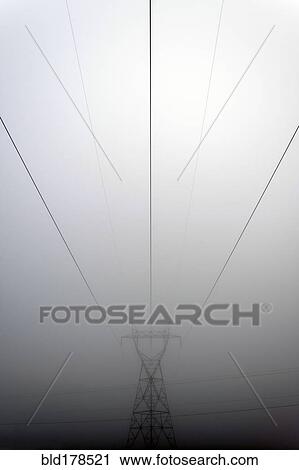 Stock Image - Power lines and foggy sky. Fotosearch