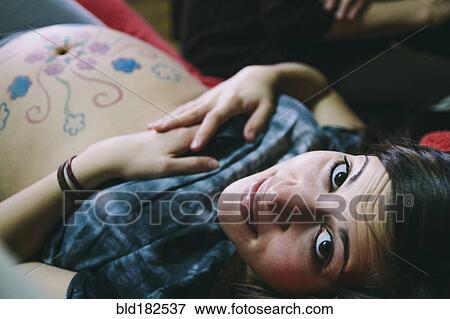 Pregnant Caucasian woman with drawings on belly View Large Photo Image Stock Photo - Pregnant Caucasian woman with drawings on belly. Fotosearch