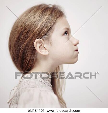 Stock Image - Profile of Caucasian teenage girl looking up. Fotosearch