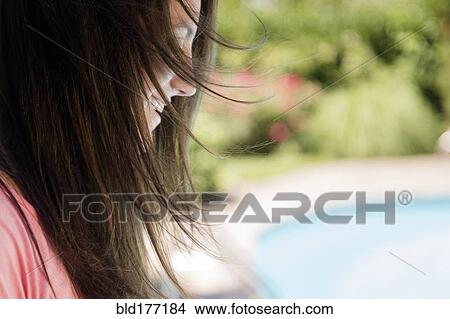 Picture - Profile of Caucasian woman outdoors. Fotosearch