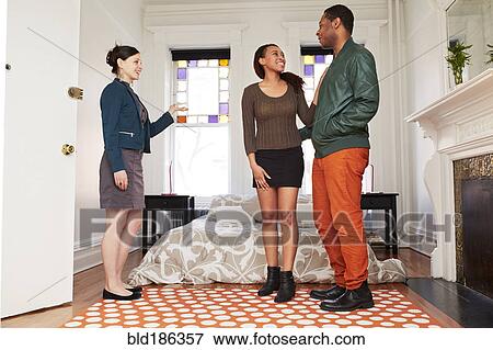 Realtor showing apartment bedroom to couple View Large Photo Image Stock Photo - Realtor showing apartment bedroom to couple. Fotosearch