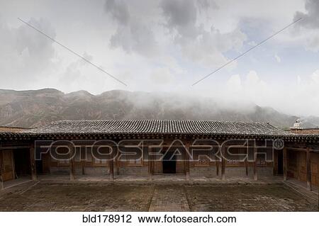 Stock Image - "Remote monastery and cloudy sky, Qinghai, Tibet, China". Fotosearch