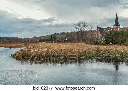Stock Photo - River and church in rural landscape. Fotosearch
